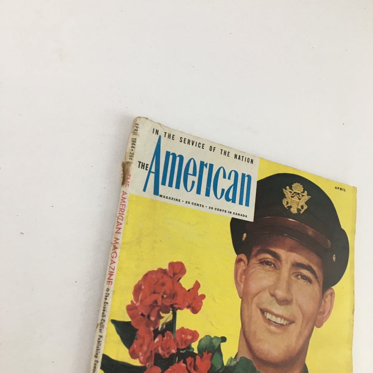 Cover of The American Magazine April 1944 featuring a smiling Captain W. S. Richmond with vibrant flowers, photographed by Paul D'Ome.