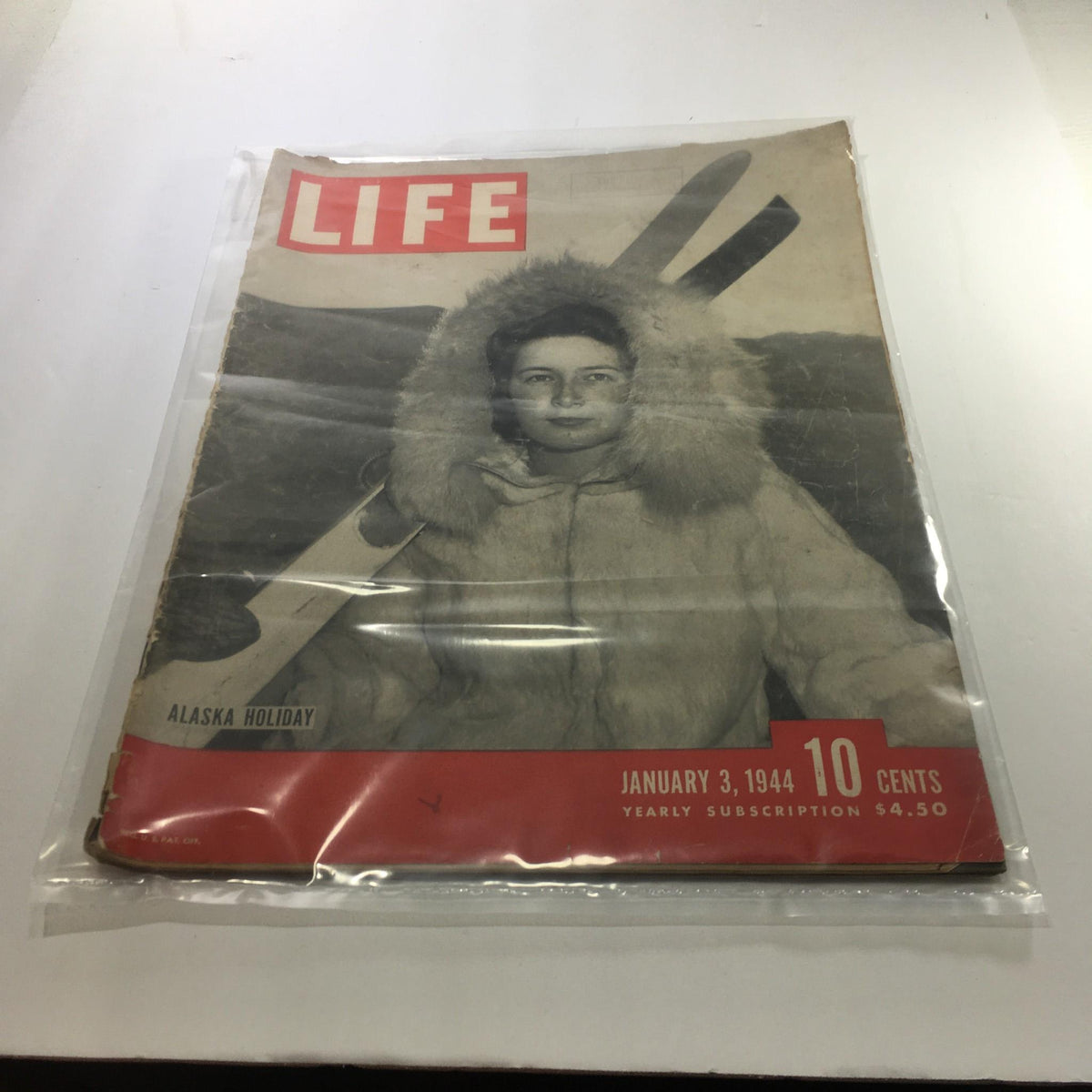 Cover of Life Magazine: January 3, 1944 - Alaska Holiday, featuring a woman in winter attire with skis, encapsulating the adventurous spirit of Alaska during the 1940s.