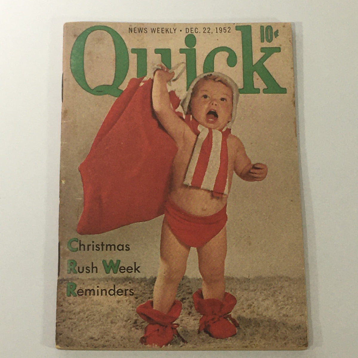 Vintage cover of VTG Quick News Weekly dated December 22, 1952, featuring a baby dressed in a red and white costume holding a cape, with the title and Christmas reminders, Vol 7 #52.