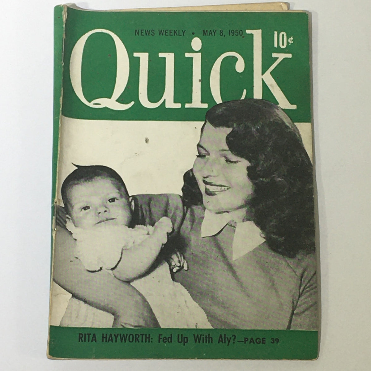 Front cover of VTG Quick News Weekly May 8 1950 featuring actress Rita Hayworth holding a baby, showcasing a nostalgic glimpse of mid-20th-century Hollywood.
