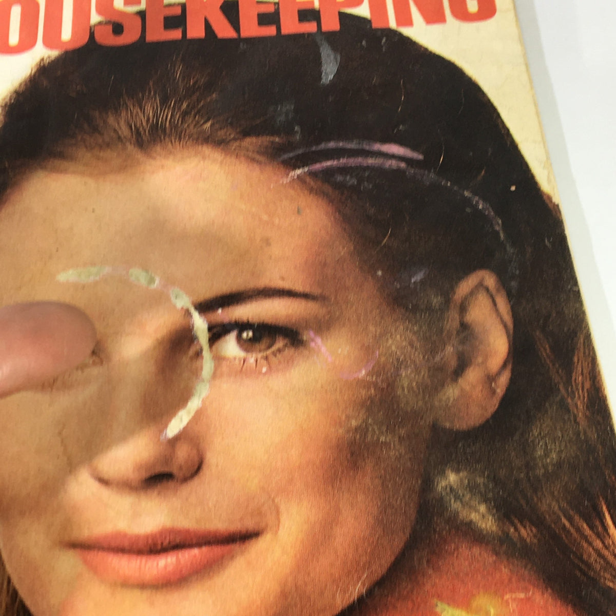 Close-up of the cover of VTG Good Housekeeping Magazine from March 1969 featuring a nostalgic image, showing minor age-related wear, including a slight mark on the woman's face, capturing the essence of 1960s culture.