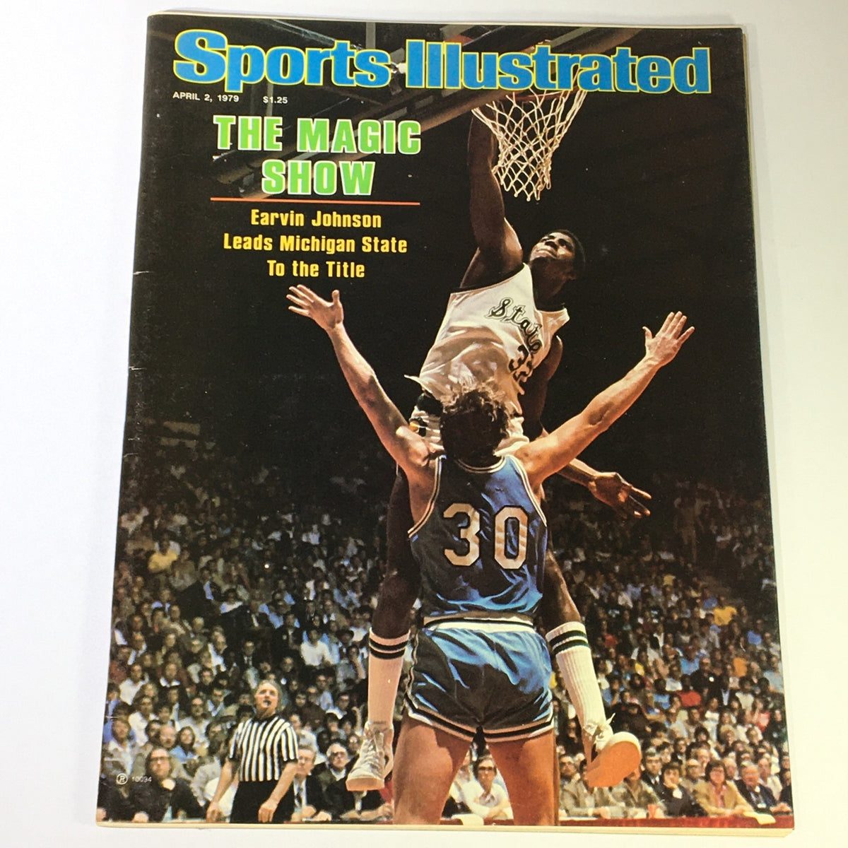 VTG Sports Illustrated Magazine April 2 1979 featuring Earvin 'Magic' Johnson in action during a basketball game, showcasing his athleticism as he jumps to dunk, amidst a vibrant crowd.