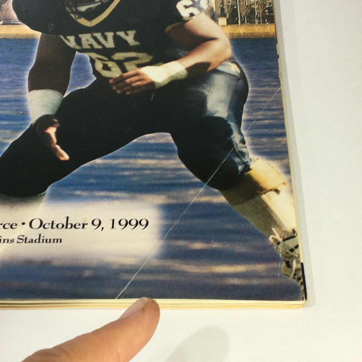 Close-up view of the magazine cover highlighting Navy vs Air Force with a folded crease, featuring Senior Center Terrence Anderson and the date October 9, 1999.