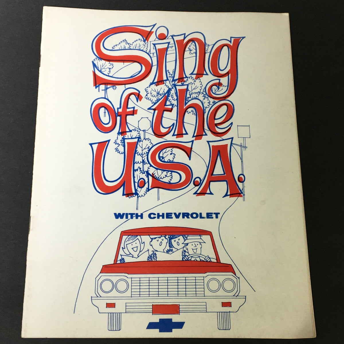 Cover of the 1964 Sing of the U.S.A. with Chevrolet Alphabetical Listings of Songs Songbook featuring colorful graphics and a retro illustration of people in a car.
