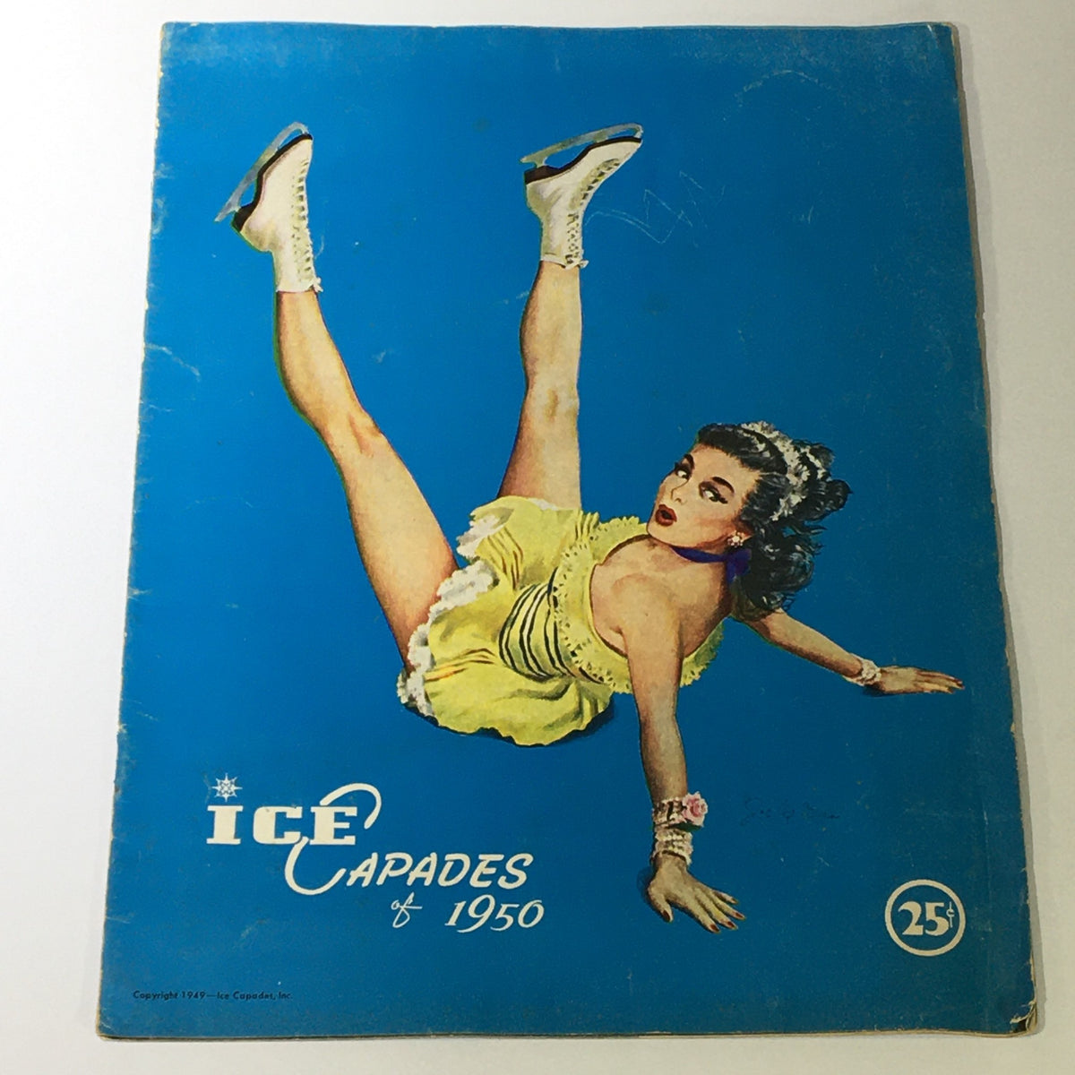 Vintage Ice Capades brochure cover from 1950 featuring a female ice skater in a yellow costume against a blue background, a Walt Disney production.