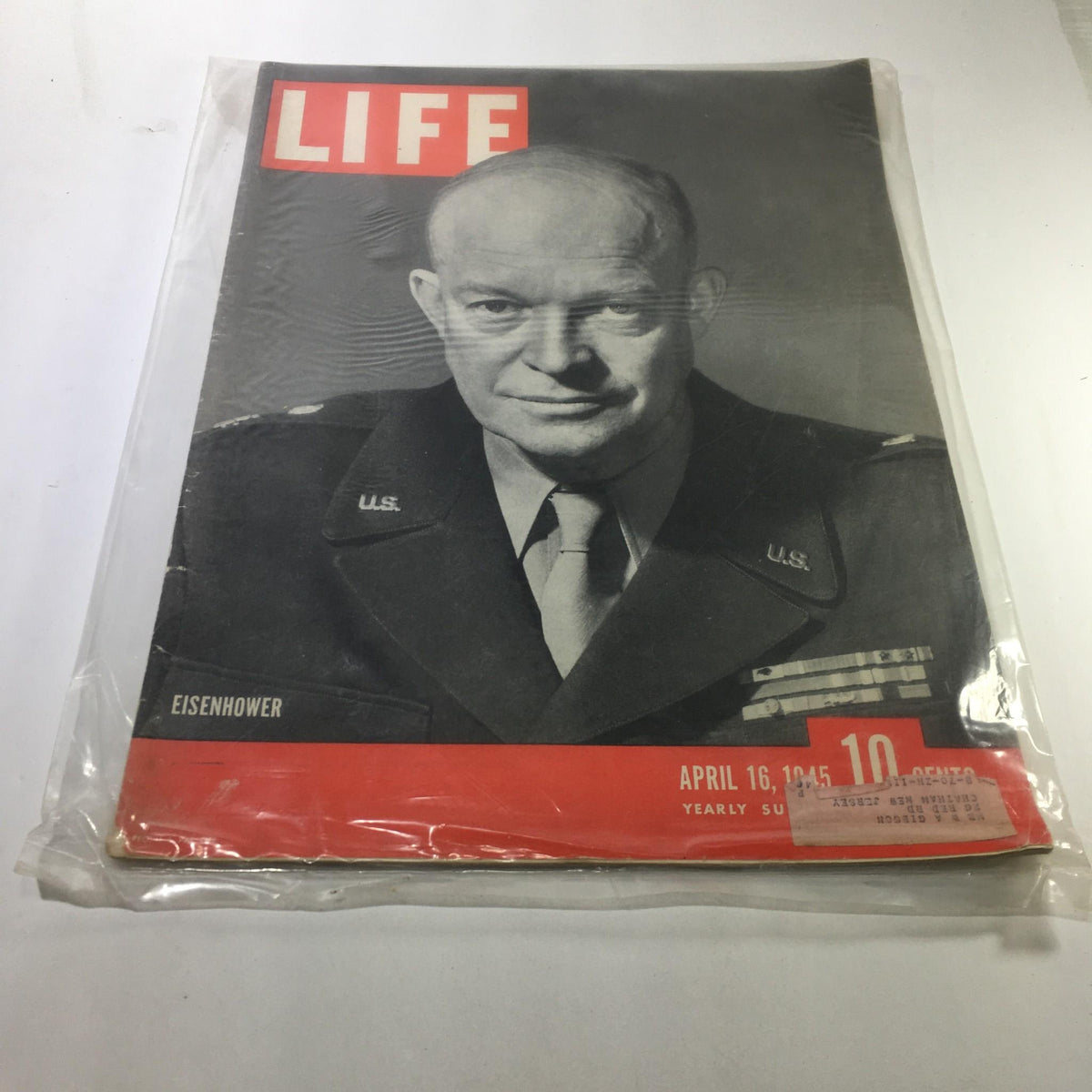 Cover of Life Magazine dated April 16, 1945, featuring General Dwight D. Eisenhower, showcasing a significant moment from World War II. This iconic magazine is preserved in good condition with a protective plastic covering.