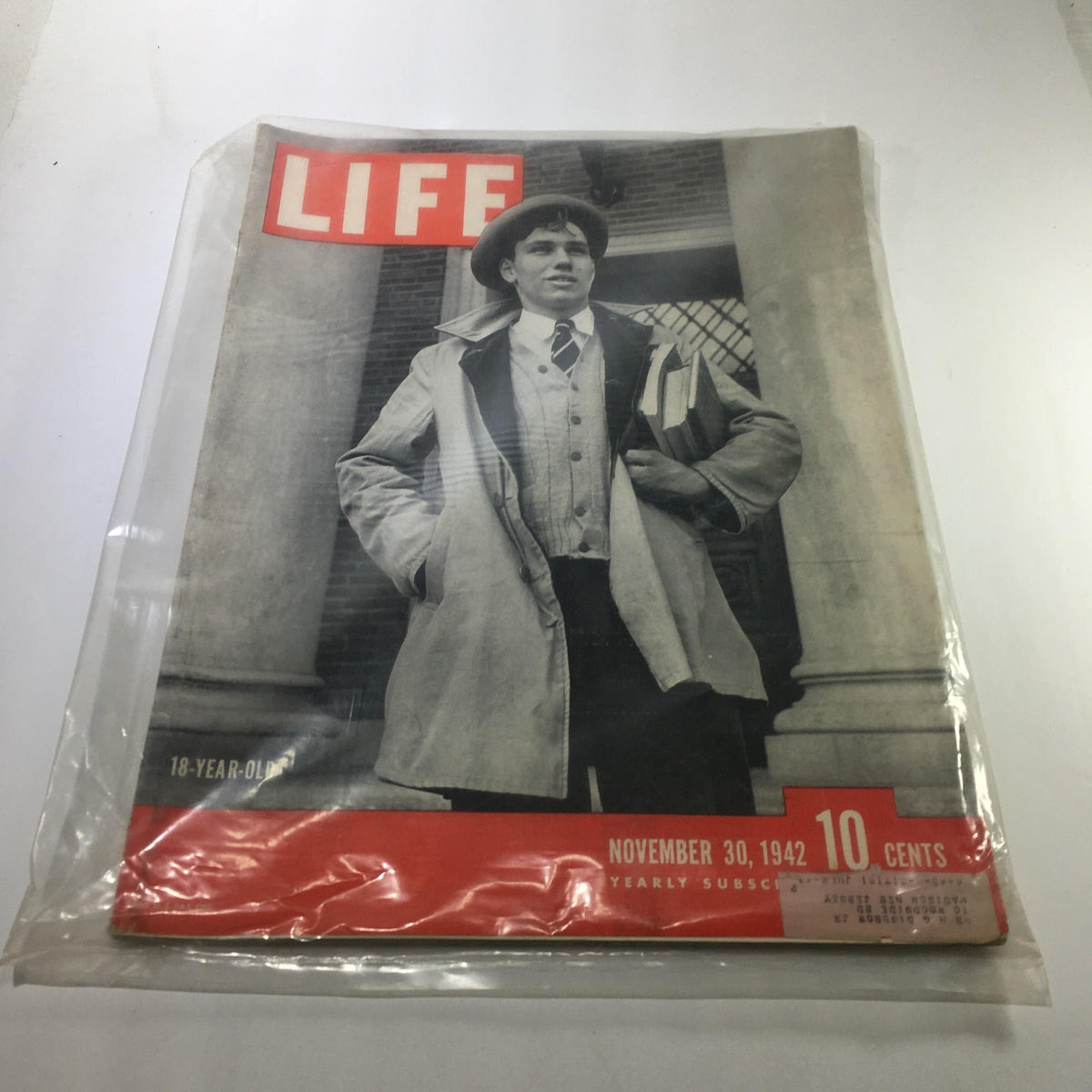 Life Magazine cover from November 30, 1942, featuring an 18-year-old in a stylish coat, holding books, captured in a historical setting. Ideal for collectors of vintage magazines.