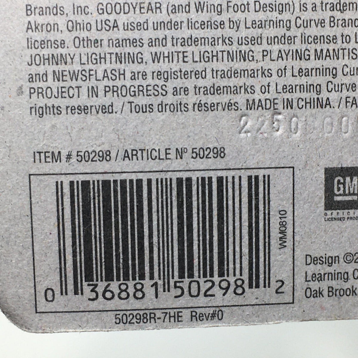 Back of packaging for Johnny Lightning Black with Flames 1987 Chevy Monte Carlo SS, showcasing item number, barcode, and licensing information.