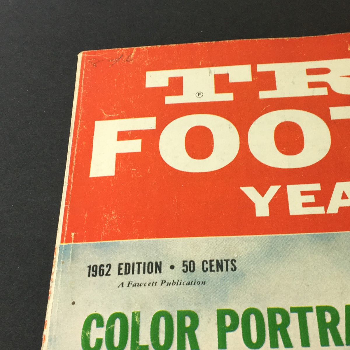 Close-up of the cover of VTG True's Football Yearbook 1962 Edition, showcasing the title in bold text with a bright orange and green color scheme, emphasizing its vintage appeal.