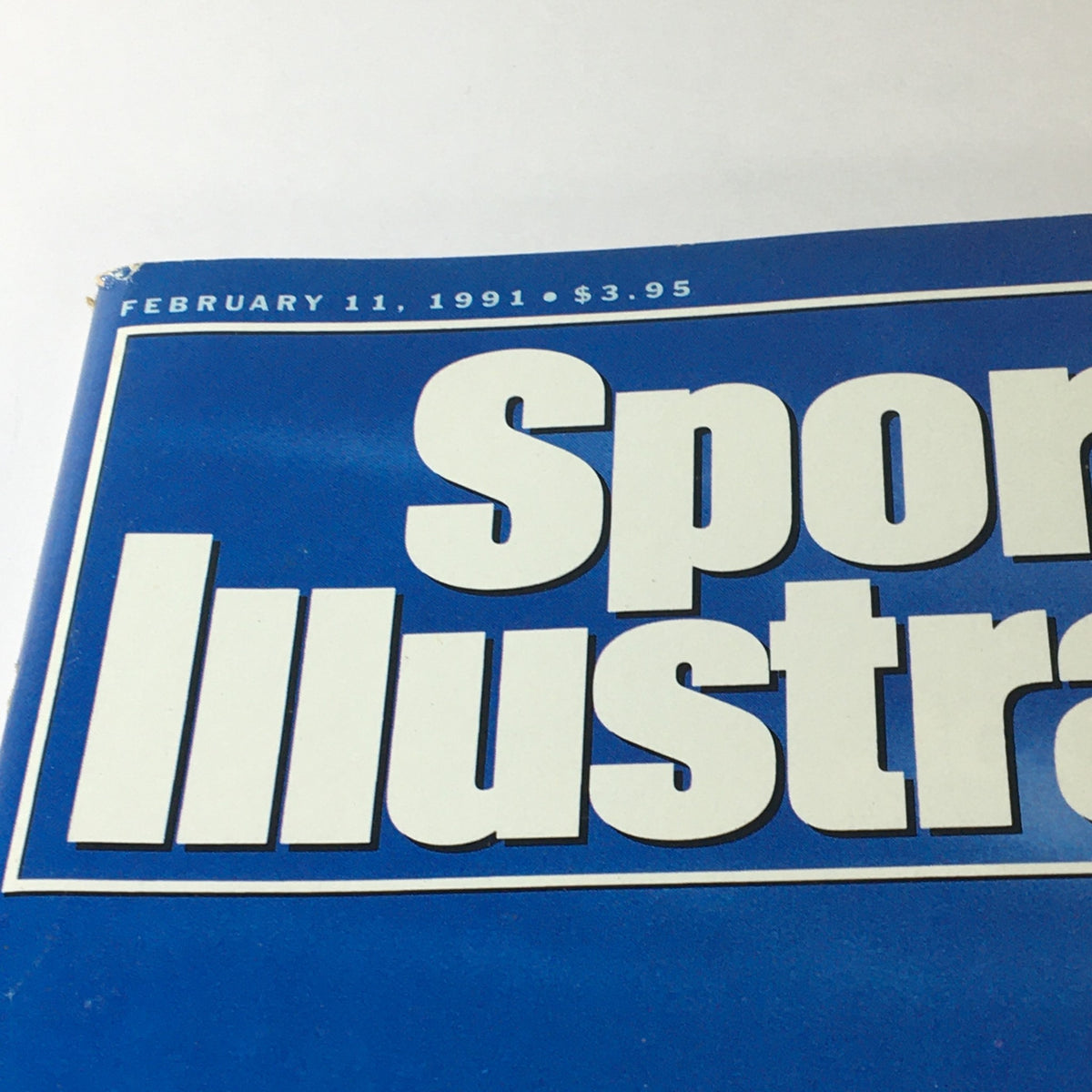 Close-up of the Sports Illustrated Magazine title and date, showing February 11, 1991, indicating the issue featuring model Ashley Montana.