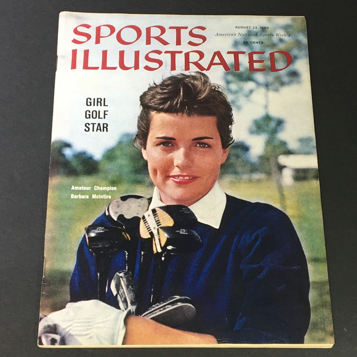 Cover of Sports Illustrated Magazine from August 22, 1960 featuring golf star Barbara McIntire, highlighting her status as an amateur champion with a backdrop of nature.