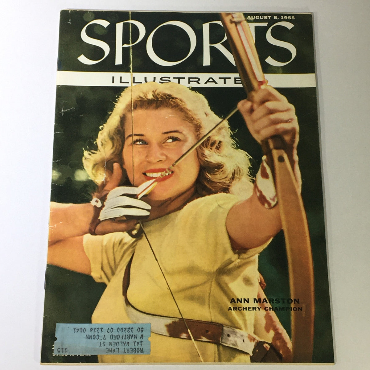 VTG Sports Illustrated Magazine cover from August 8, 1955 featuring Archery Champion Ann Marston aiming an arrow, showcasing vintage sports memorabilia.