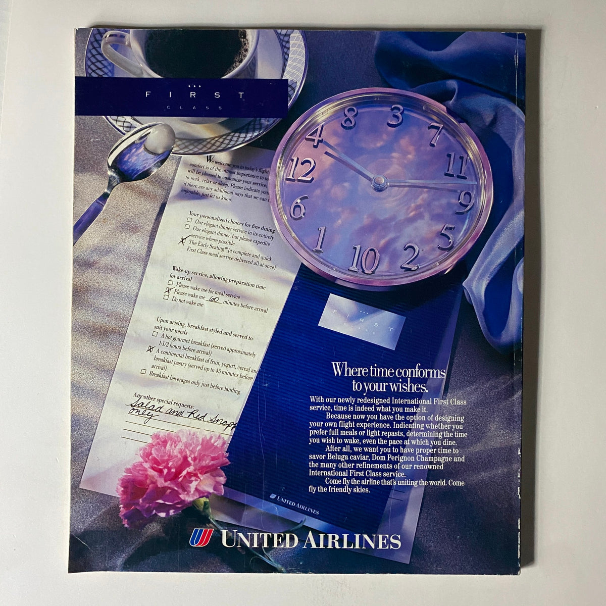Advertisement in Fortune Magazine, highlighting United Airlines' International First Class service with an elegant design featuring a clock and catering options, emphasizing personalized travel experiences.