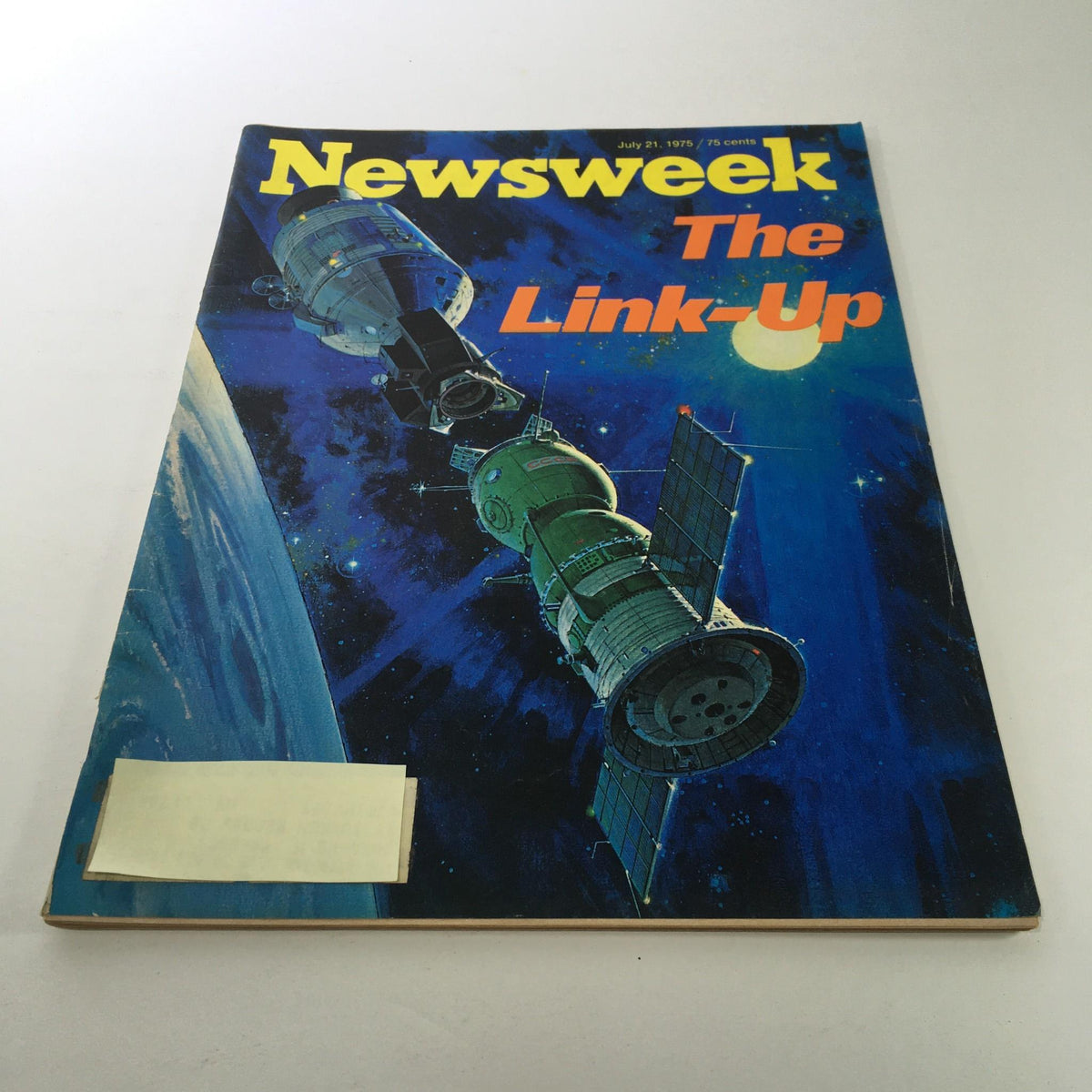 Cover of Newsweek Magazine from July 21, 1975, titled 'The Link-Up', featuring a vibrant space-themed illustration showcasing satellites in orbit against a dark blue background.