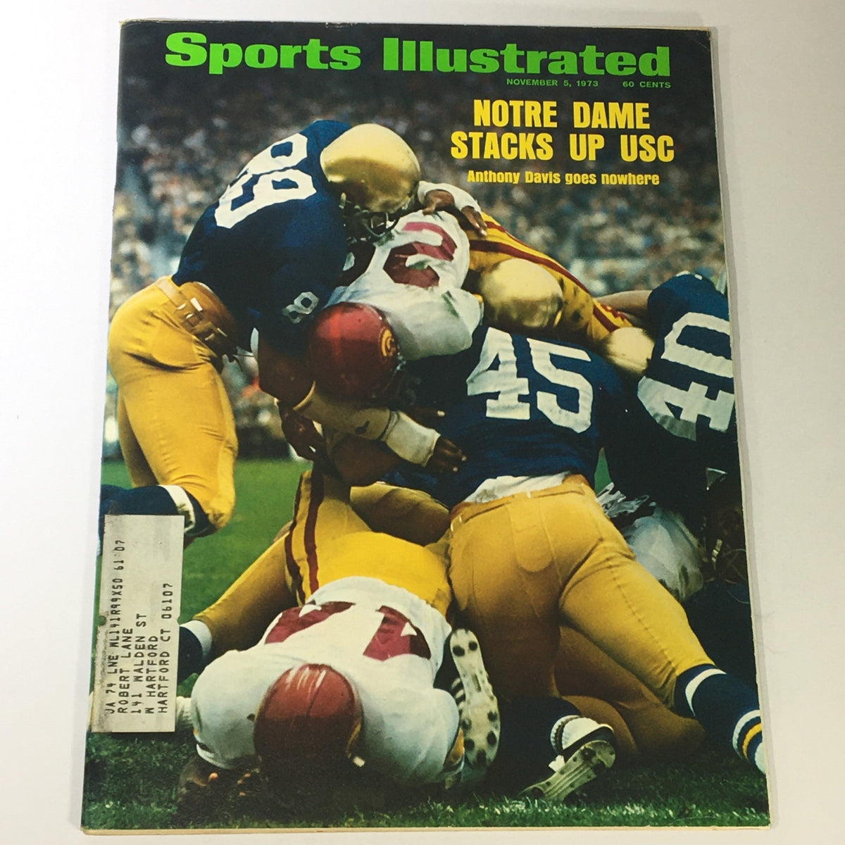Vintage Sports Illustrated magazine cover from November 5, 1973 featuring a dramatic college football scene with players in action; highlights Anthony Davis from Notre Dame battling against USC, showcasing the competitive spirit of college sports.