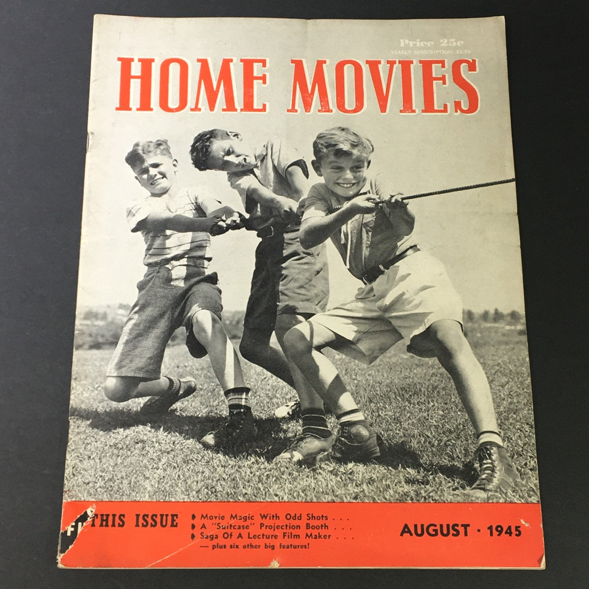 VTG Home Movies Magazine August 1945 cover featuring three boys playing tug-of-war, showcasing vintage film culture and highlights from the magazine issue.