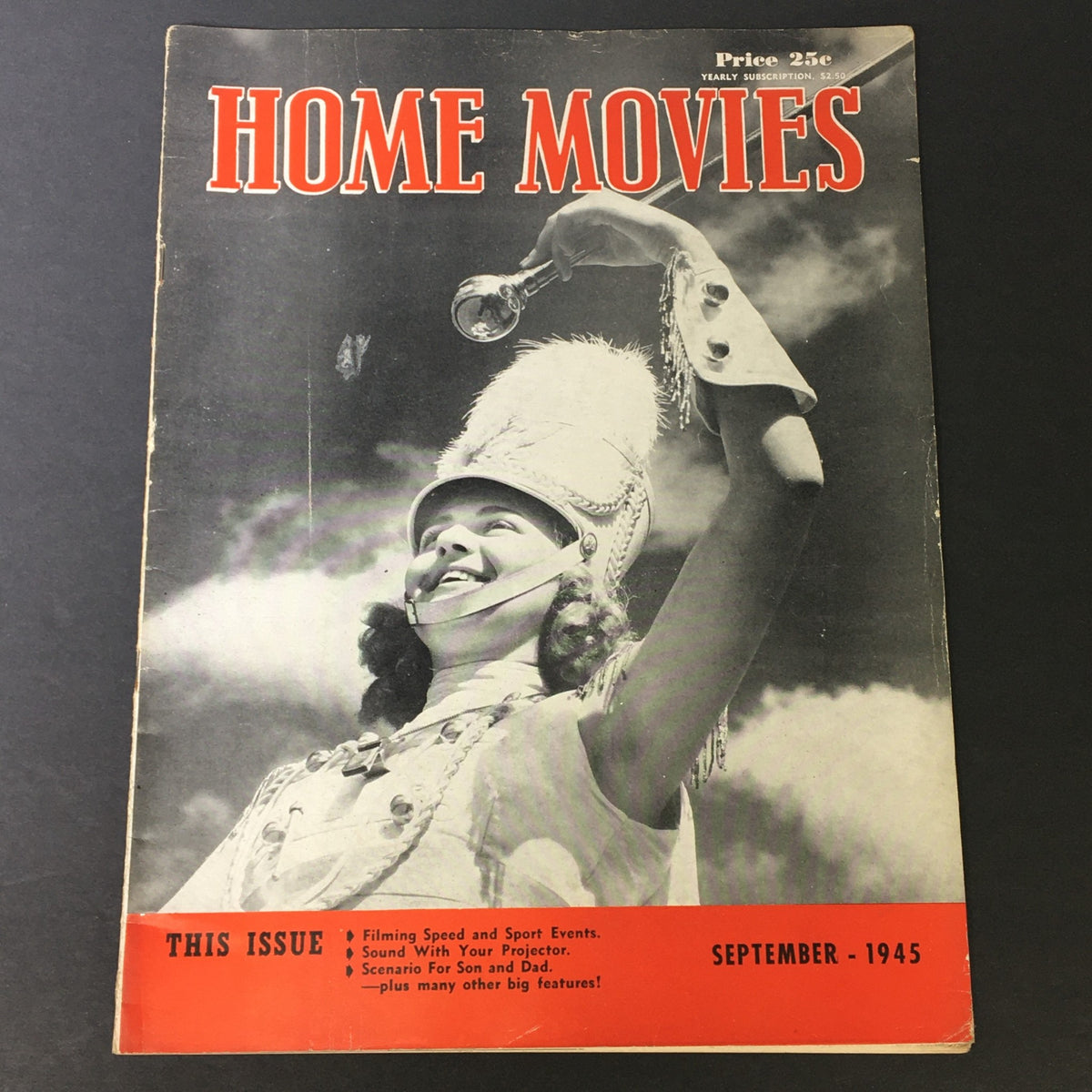 Cover of VTG Home Movies Magazine September 1945 featuring a smiling woman in a marching band costume holding a megaphone, highlighting themes of filming sports and events.