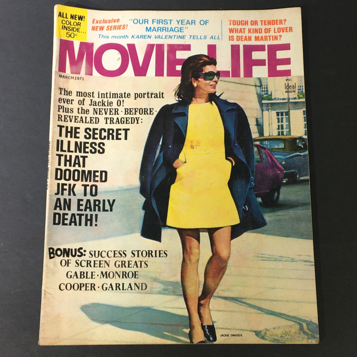 Cover of VTG Movie Life Magazine March 1971 featuring Jackie Onassis in a stylish yellow dress, highlighting critical articles including a portrait of Jackie O! and a tragedy detailing the secret illness that impacted JFK. Collectible magazine featuring Marilyn Monroe, Gary Cooper, and Judy Garland.