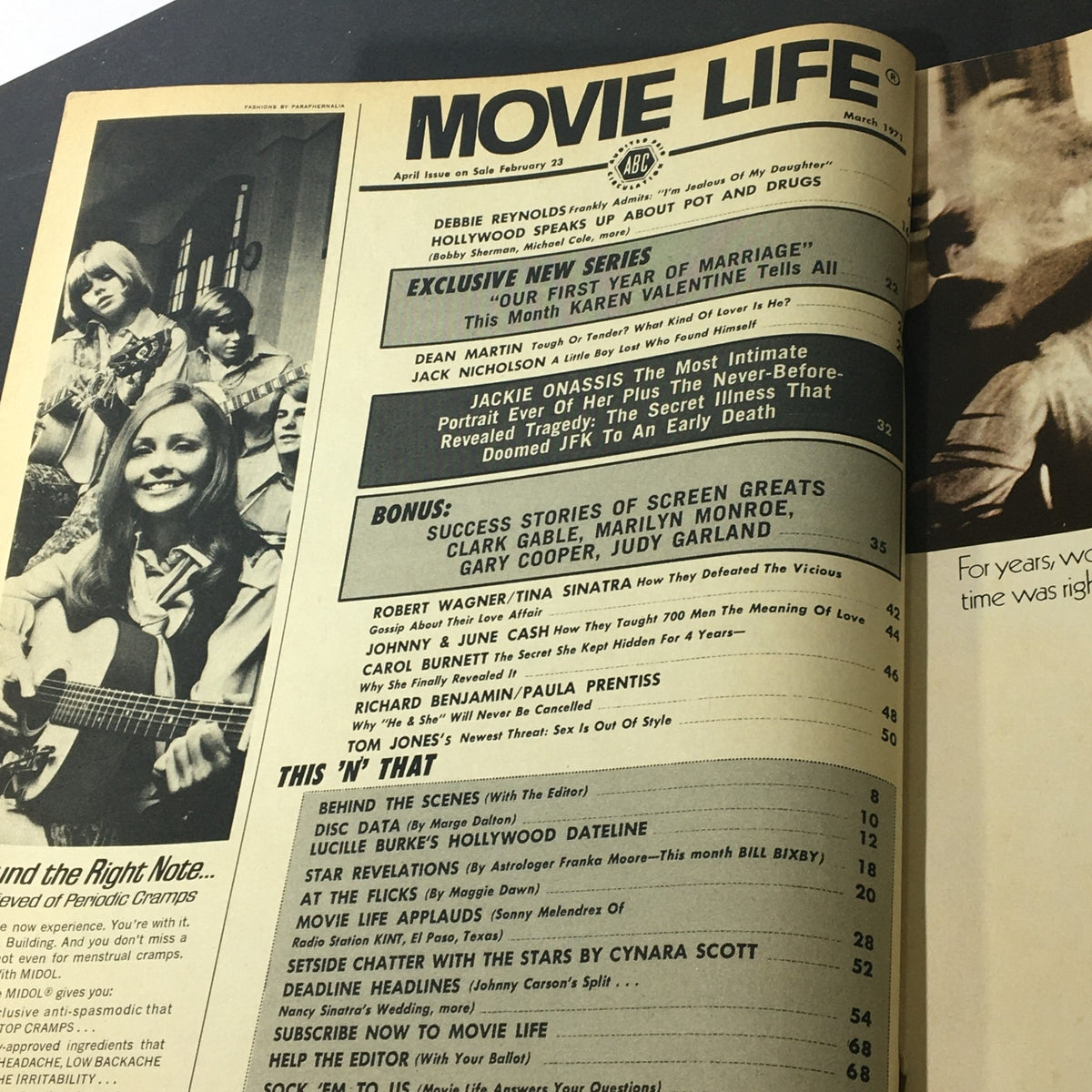Inside view of VTG Movie Life Magazine March 1971, showcasing the table of contents with articles about Jackie Onassis, Marilyn Monroe, Gary Cooper, and Judy Garland, along with other notable content, emphasizing its significance as a piece of cinematic history.