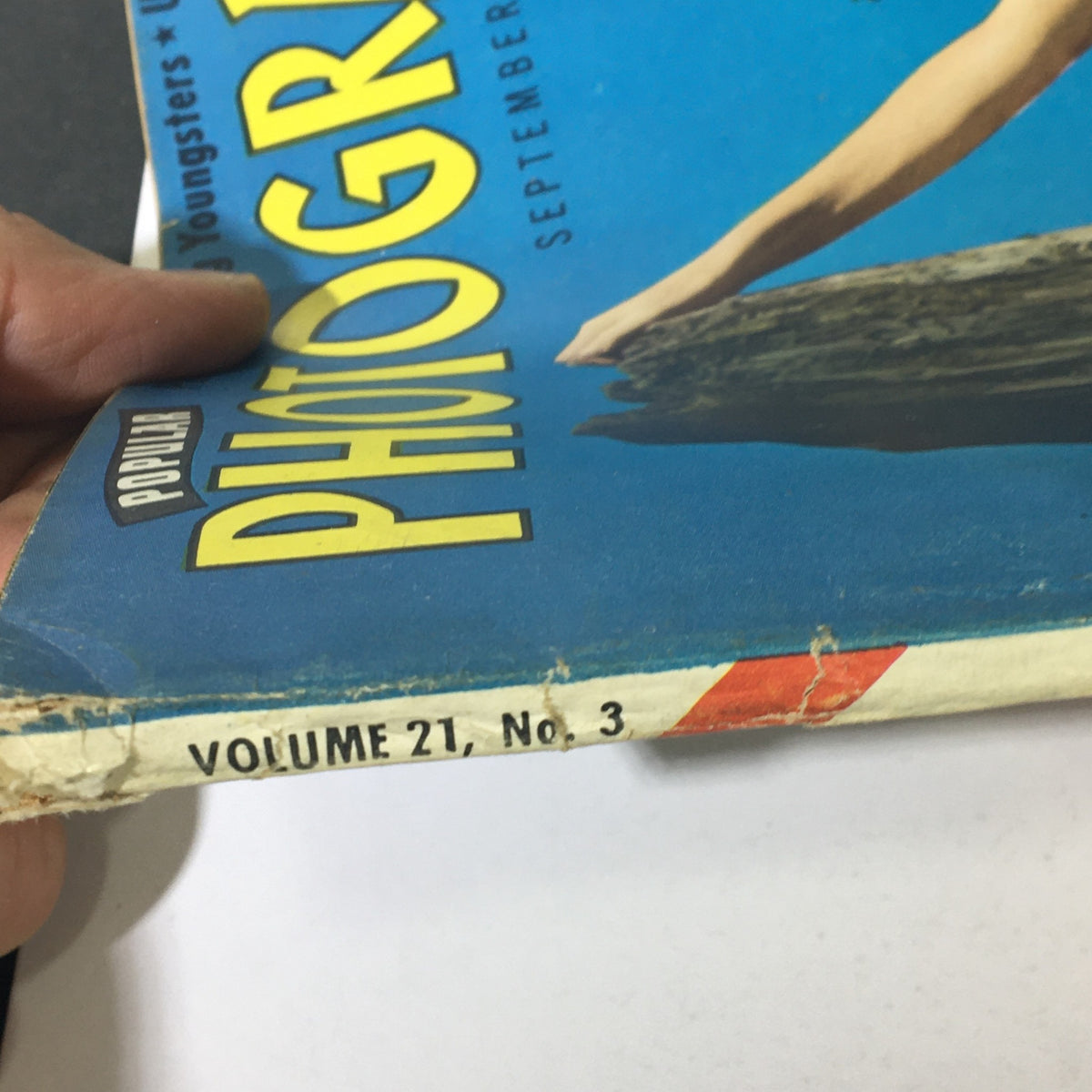 Side view of Popular Photography Magazine September 1947 Vol 21 #3 displaying the volume and issue number, highlighting its vintage appeal.