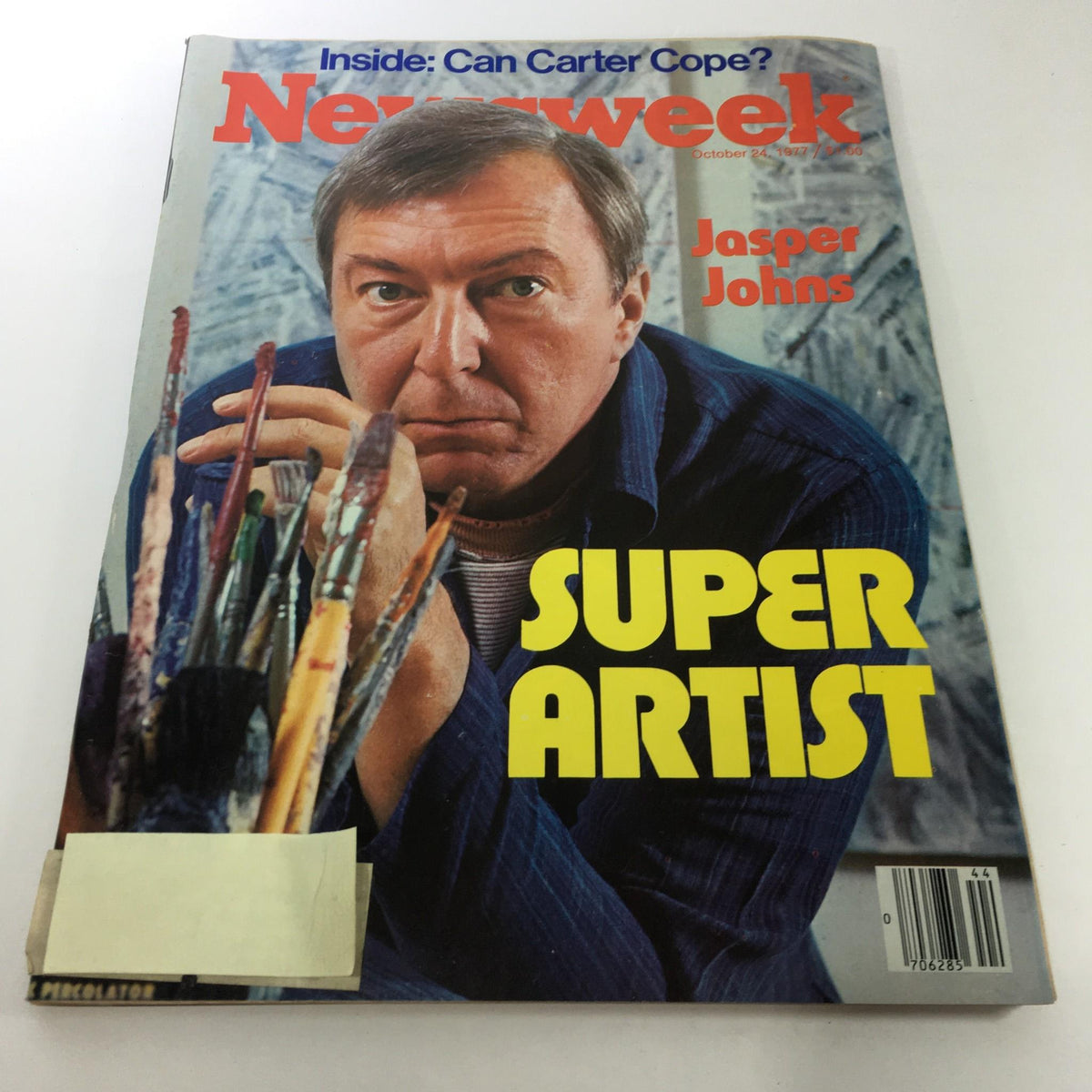 Newsweek Magazine cover from October 24, 1977 featuring Jasper Johns as 'Super Artist'. The cover displays artistic paintbrushes and vibrant typography, emphasizing the impact of contemporary art.