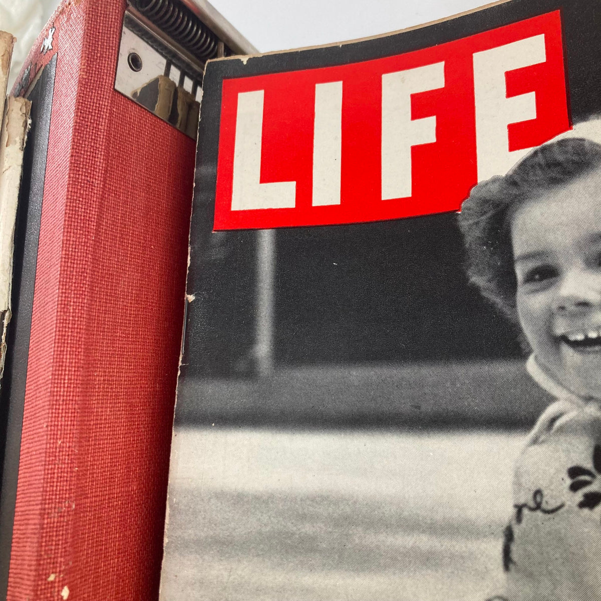 Close-up of a LIFE magazine cover depicting a joyful child, emphasizing the nostalgia and happiness of early 1950s America.