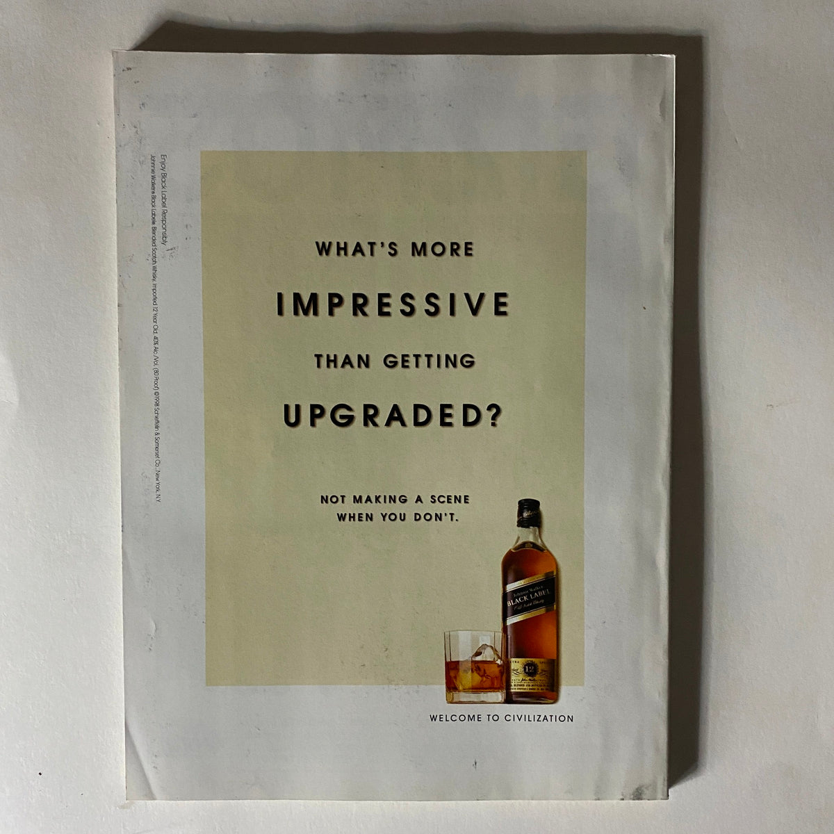 Back cover of Fortune Magazine, March 30, 1998, showcasing an advertisement with the text 'What's more impressive than getting upgraded?' and featuring a whiskey bottle.