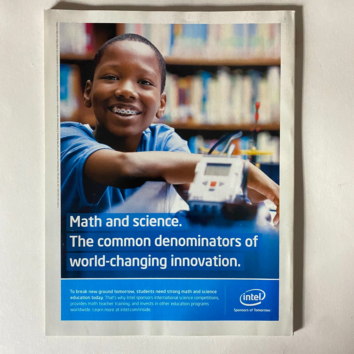 Advertisement featuring a smiling young boy with a model robot, promoting math and science education as fundamental to innovation, alongside the title 'Fortune Magazine October 26, 2009 It’s China’s World (We Just Live in It) VG'.