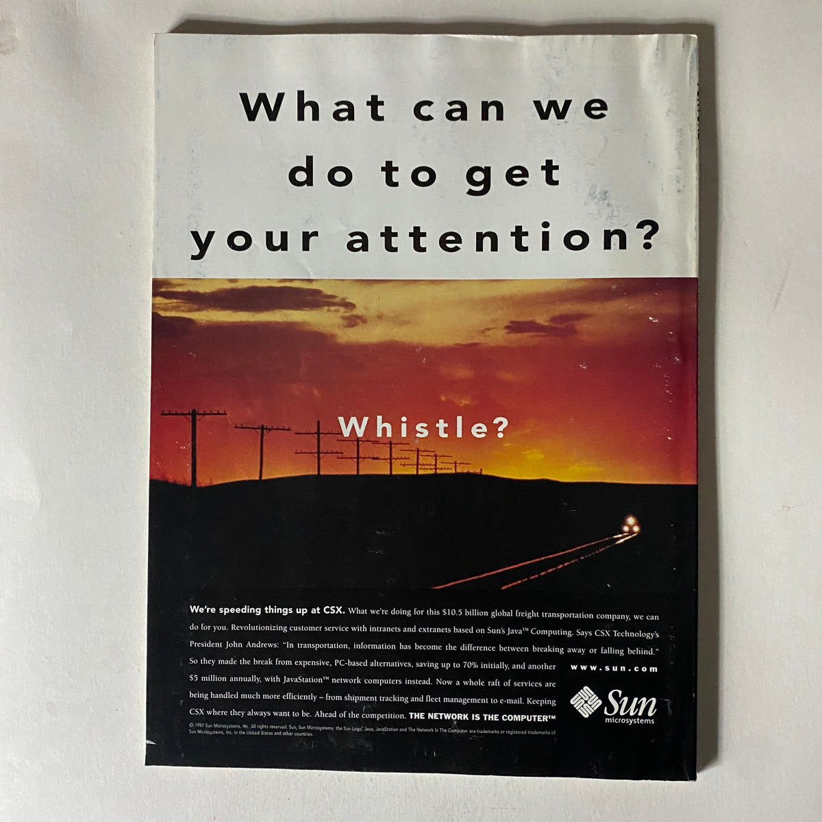 Back cover of Fortune Magazine July 21, 1997, showcasing an advertising piece asking 'What can we do to get your attention?' with a scenic sunset background.