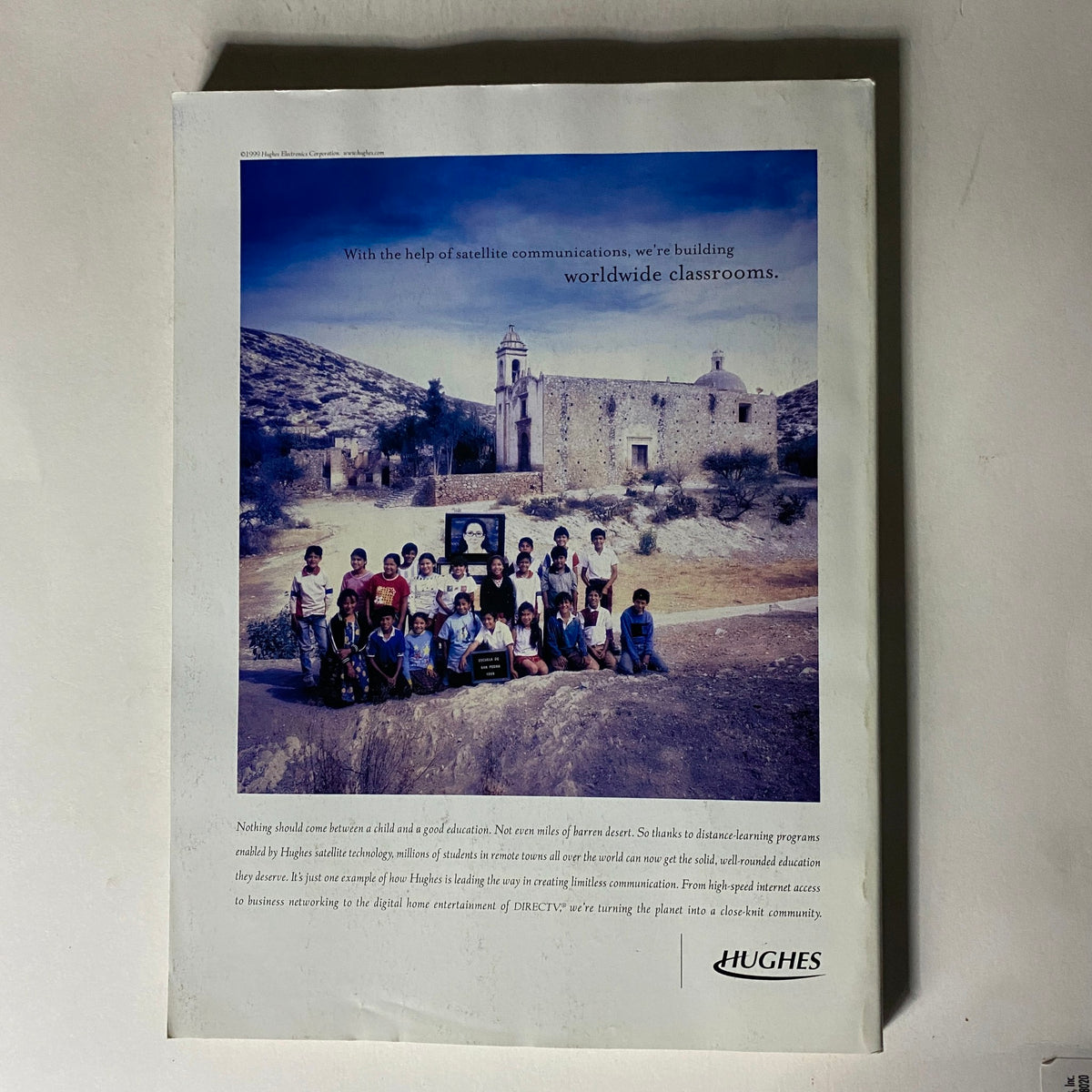 Fortune Magazine May 24, 1999 featuring Jeff Bezos, showcasing a group of students in a remote landscape, highlighting educational initiatives supported by satellite communication. The image reflects the theme of worldwide classrooms, emphasizing the significance of technology in education.