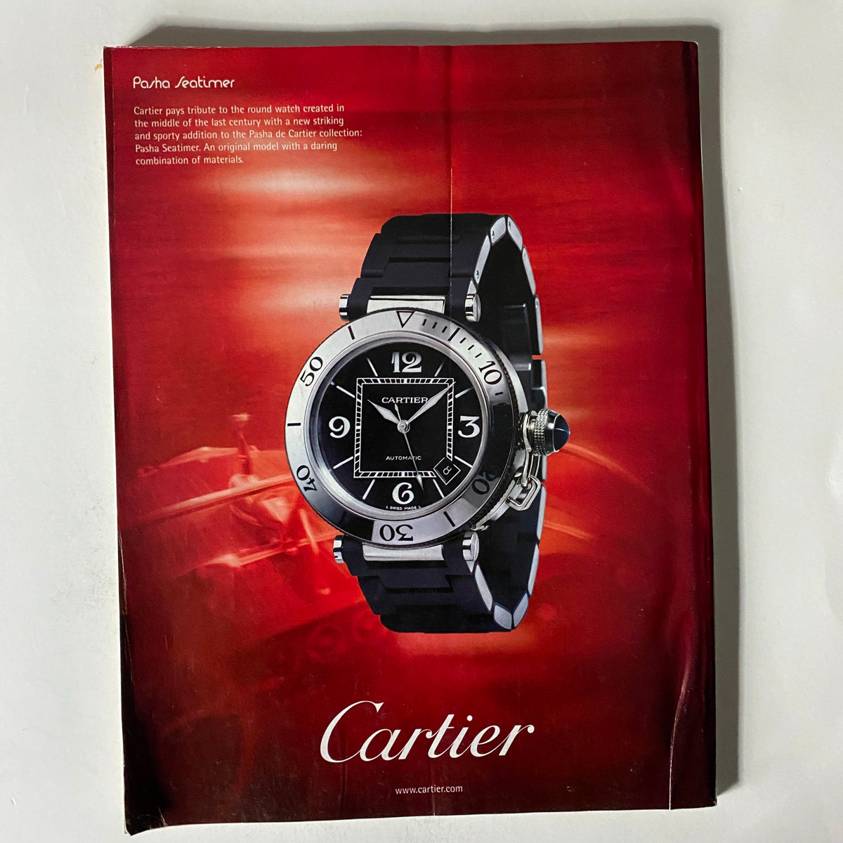 Back cover of Fortune Magazine May 15, 2006, featuring a Cartier advertisement for a stylish watch with a striking red background.