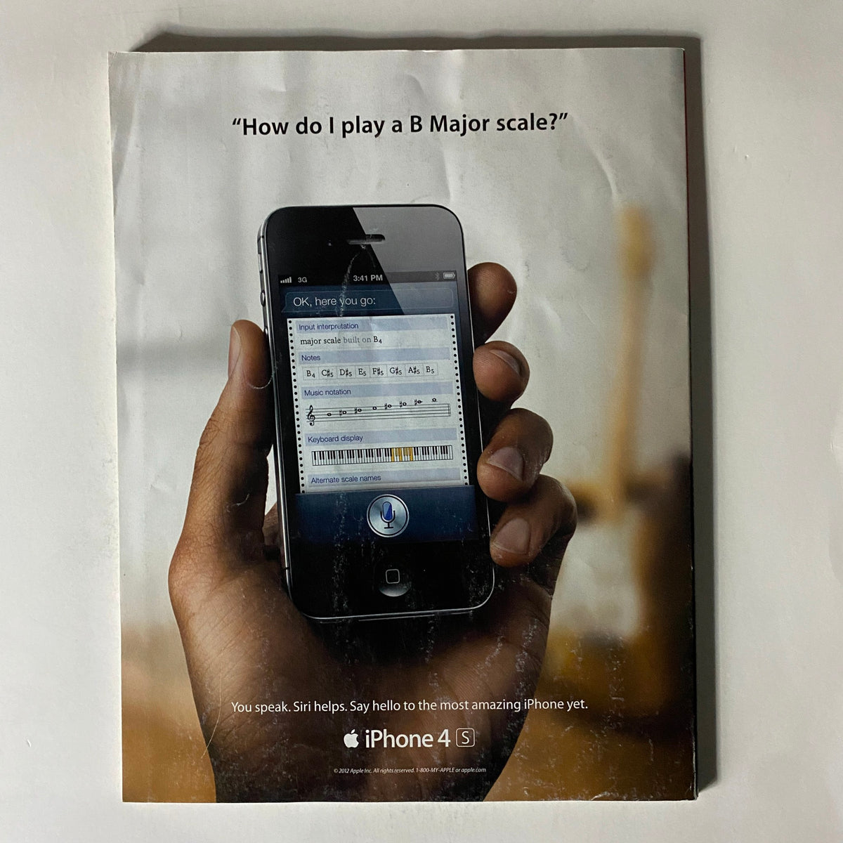Back cover advertisement of the February 27, 2012 issue of Fortune Magazine showcasing an iPhone 4S with Siri text prompts, highlighting its features. This cover emphasizes the technological advancements discussed in the magazine.