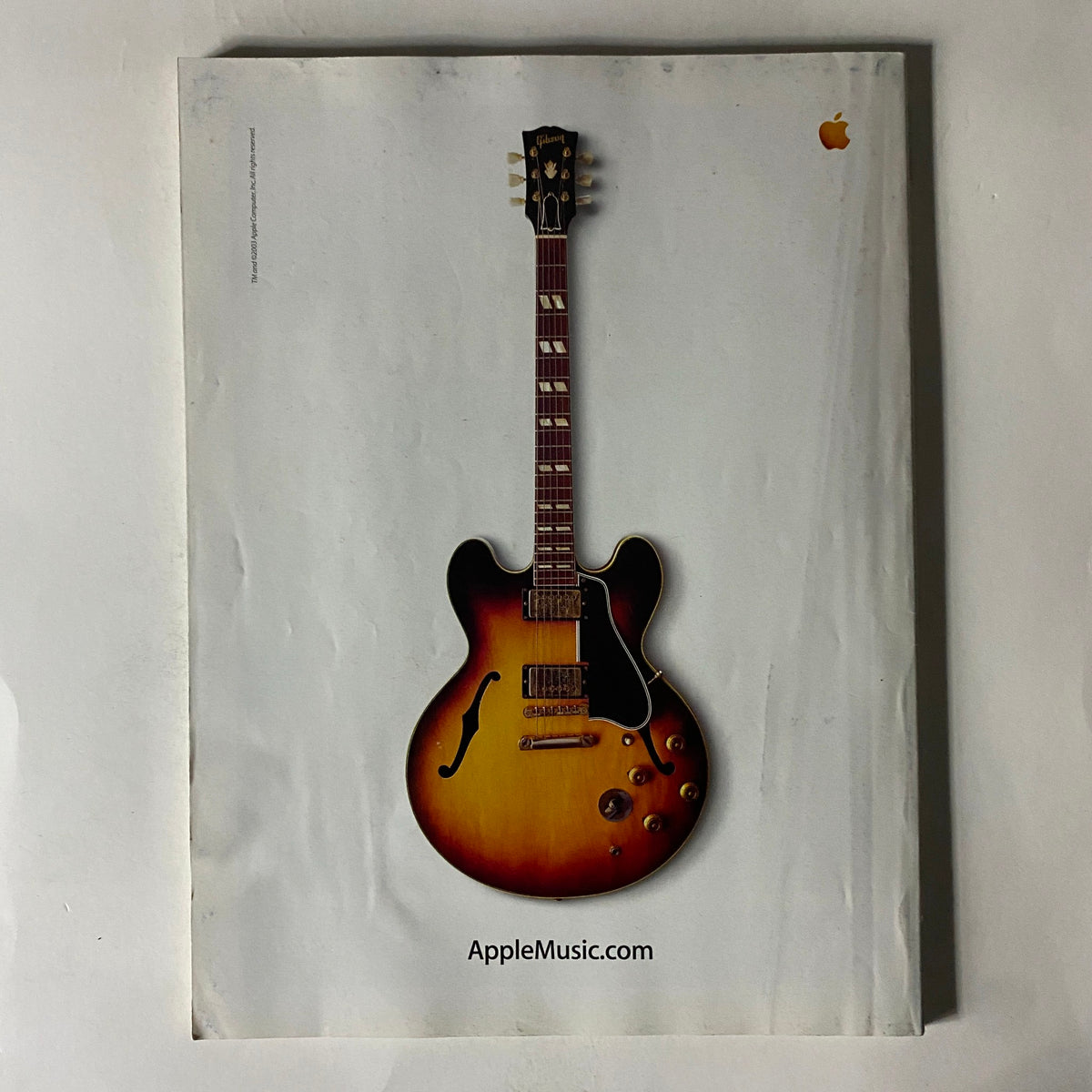 Back cover of Fortune Magazine, May 26, 2003, featuring an advertisement for Apple Music with an image of a vintage guitar, showcasing the intersection of music and technology.