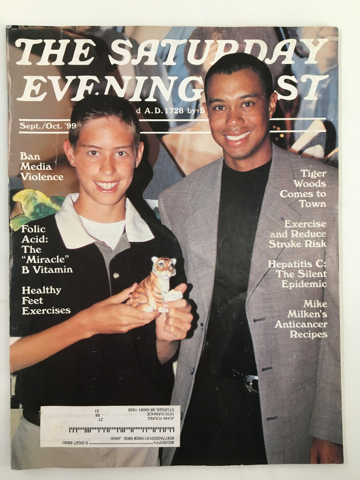 The Saturday Evening Post September 1999 magazine cover featuring Tiger Woods and a young boy holding a toy tiger, celebrating Tiger Woods's rise in golf and his influence on sports.