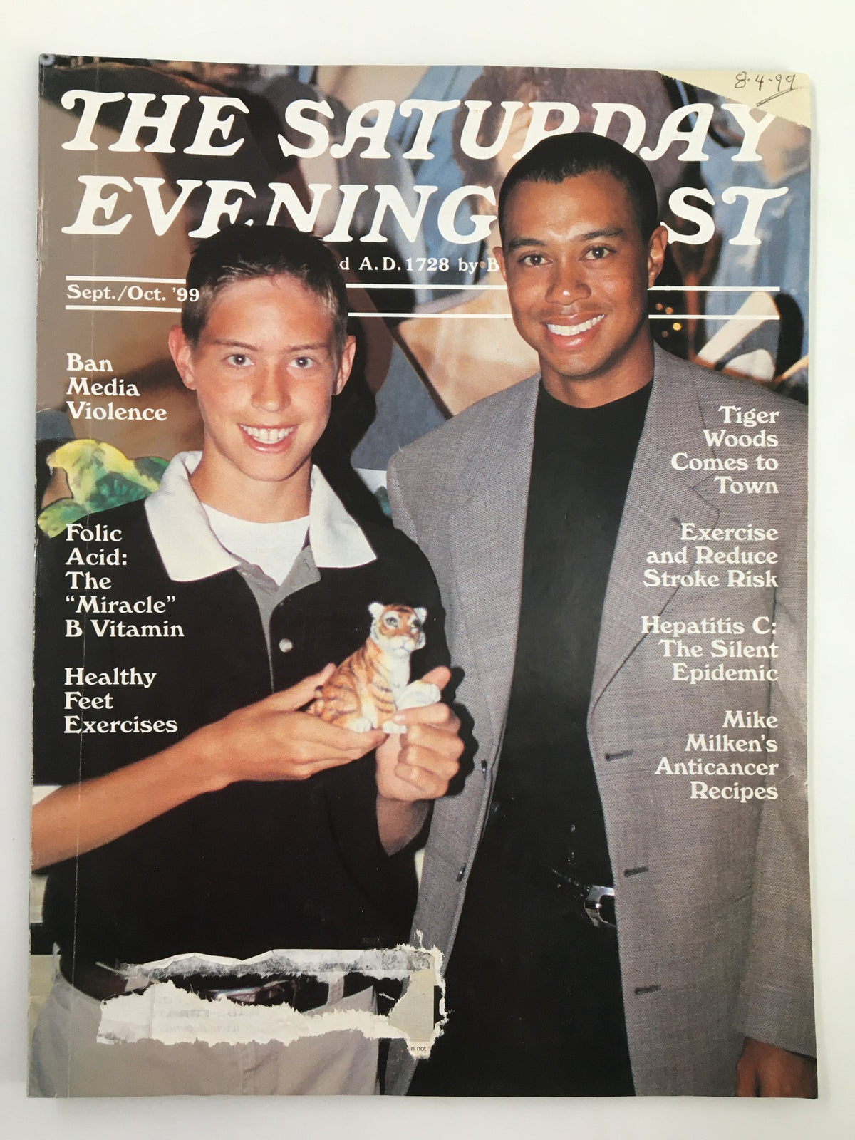 Cover image of The Saturday Evening Post from September 1999, featuring Tiger Woods and a young boy holding a tiger figurine. The cover highlights topics like media violence and health tips.