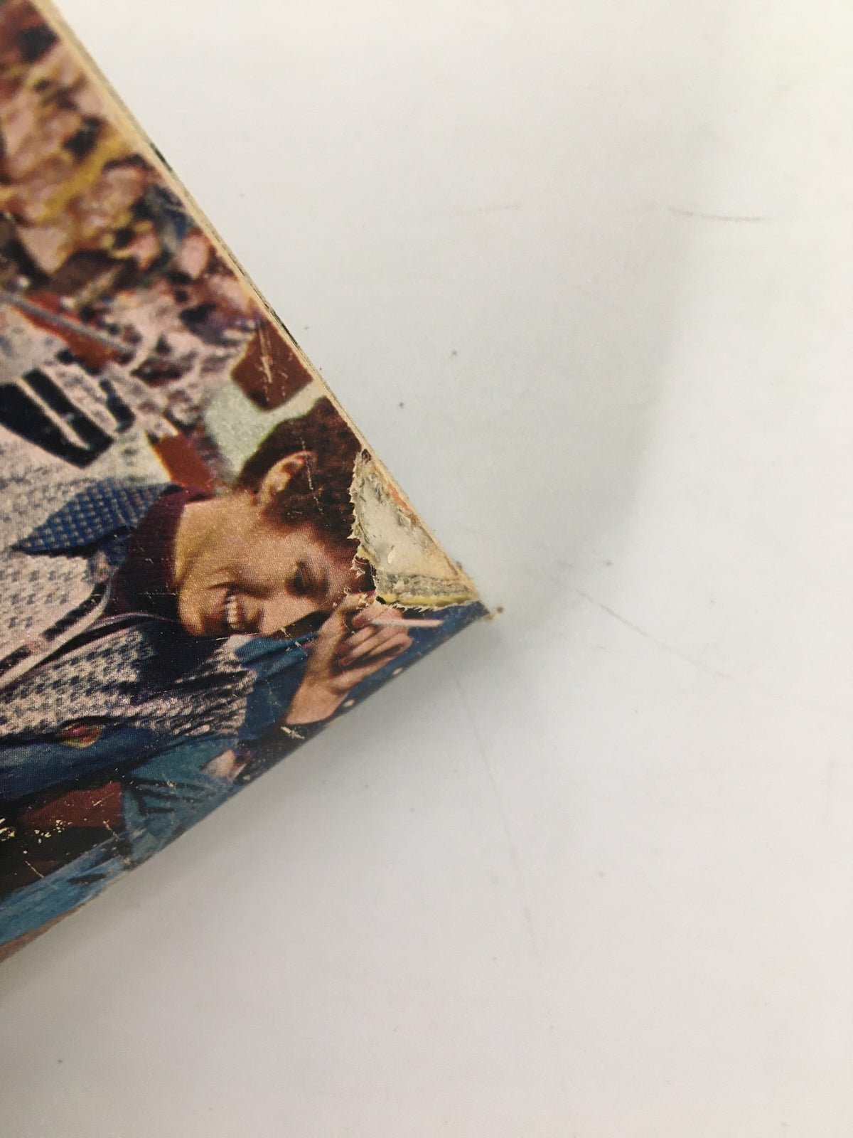 Close-up view of the corner of TV Guide Magazine from July 27, 1974 featuring Lee McCain, showing visible wear and tear with frayed edges, indicative of its vintage status.