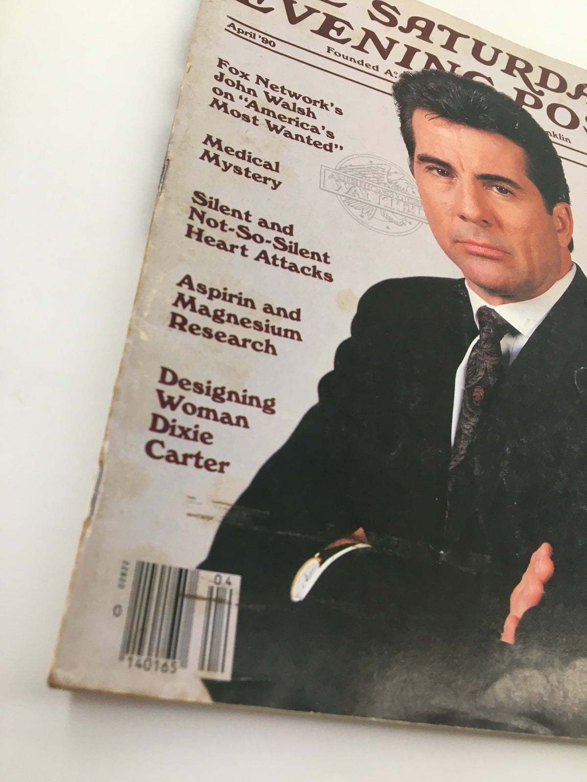 Close-up shot of the cover of The Saturday Evening Post April 1990, highlighting Fox Network's John Walsh on America's Most Wanted. The issue also includes topics like medical mysteries and health tips.