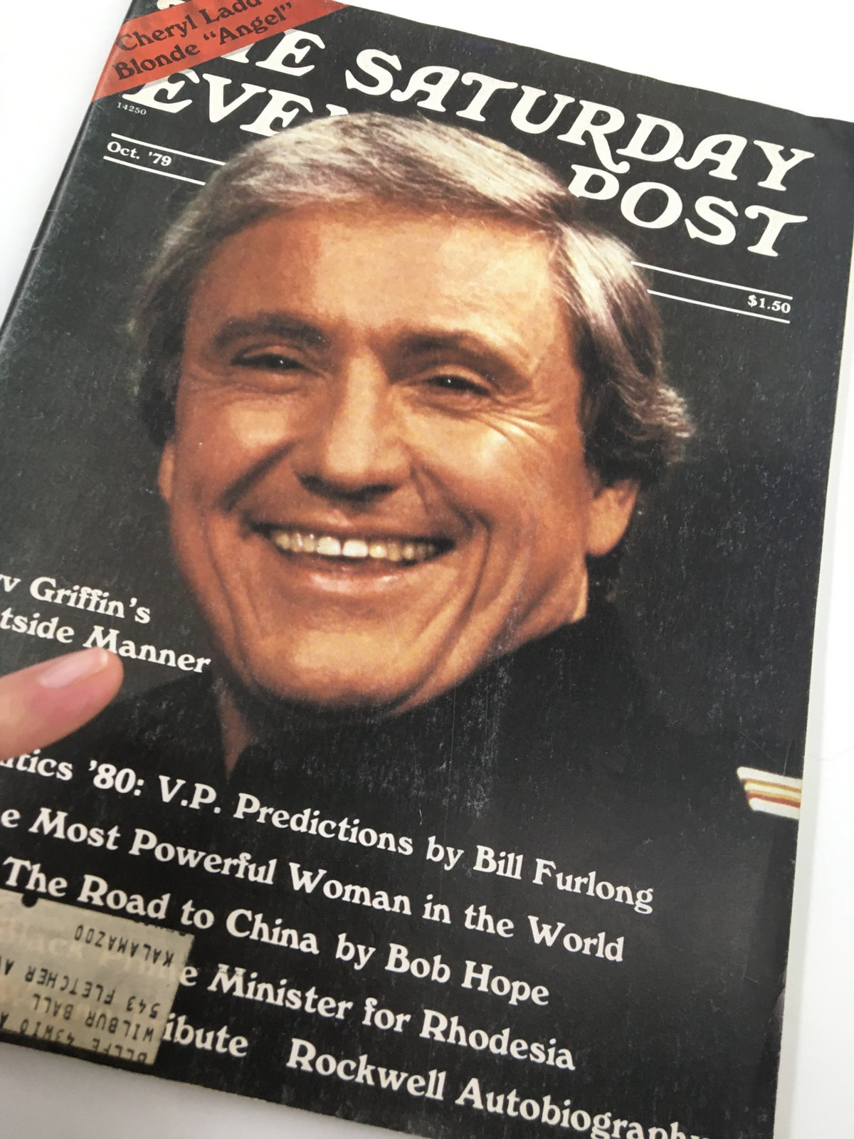 Detailed view of The Saturday Evening Post October 1979 cover with Merv Griffin's Guestside Manner, displaying a smiling Merv Griffin, and snippets of content such as articles and advertisements from the era.