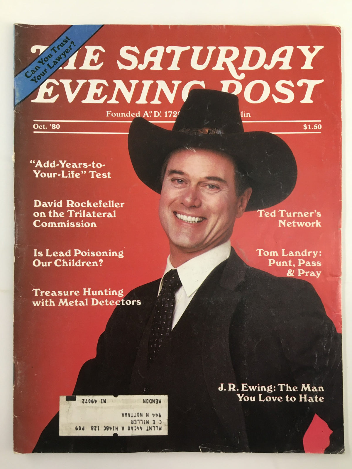 Cover of The Saturday Evening Post October 1980 featuring J.R. Ewing, known as 'The Man You Love to Hate', showcasing a vintage magazine aesthetic with a vibrant red background and a prominent image of a smiling man in a cowboy hat.