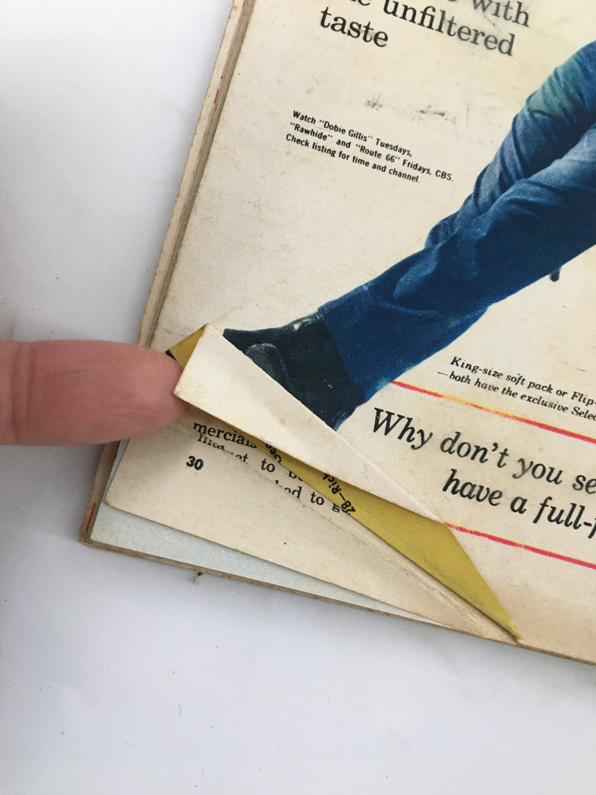 Close-up of a folded page in the TV Guide Magazine August 19 1961, illustrating a vintage advertisement and showing signs of wear.