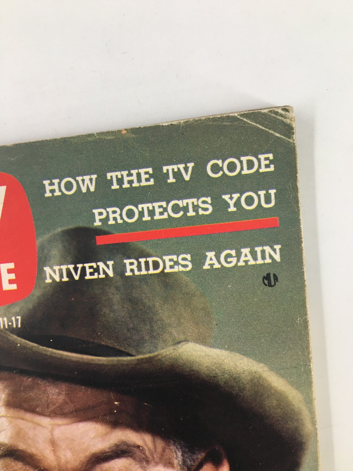 Close-up of the text on TV Guide Magazine April 11 1959 cover, stating 'How the TV Code Protects You' alongside 'Niven Rides Again', showcasing the publication's focus on television regulation.