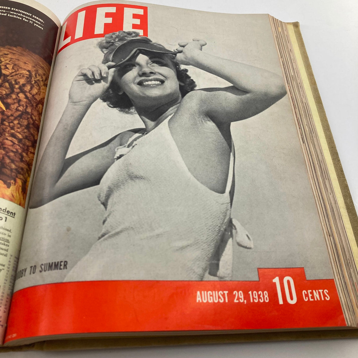 Cover of VTG 1938 Bound Life Magazine from August 29, showing a stylish woman in a vintage bathing suit enjoying the summer sun, capturing the essence of summer fashion trends.