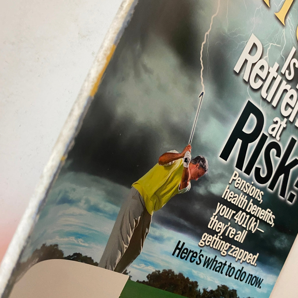 Close-up view of the Fortune Magazine March 17, 2003 cover, highlighting the golfer facing a storm, symbolizing the risks to retirement savings and financial security.
