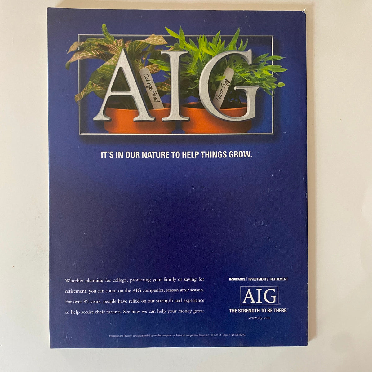 Back cover advertisement for AIG featured in a magazine, promoting their investment and insurance services with a focus on growth.