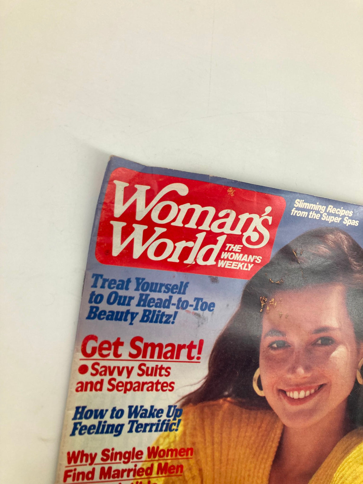 Close-up of the cover design of Woman's World Magazine May 27 1986, showcasing the vibrant title and teasers for articles on beauty and wellness.