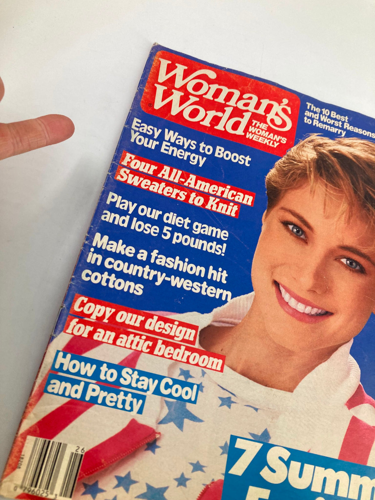 Close-up of the cover of Woman's World Magazine June 30, 1987, showing the title 'Woman's World Magazine June 30 1987 All-American Sweaters To Knit No Label' alongside features on diet games and home decor tips, with a focus on the model's cheerful expression.