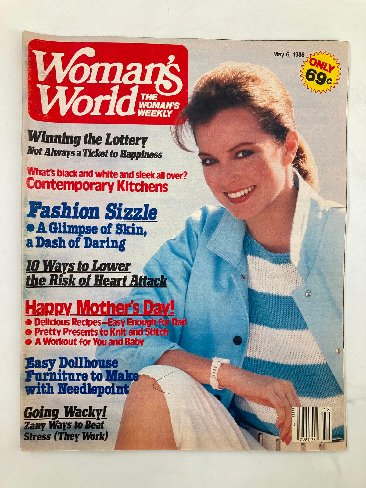 Cover of Woman's World Magazine, May 6, 1986, featuring articles on lowering heart attack risk, fashion, and Mother's Day recipes. The magazine showcases a woman in a blue cardigan smiling, emphasizing women's health and lifestyle topics.