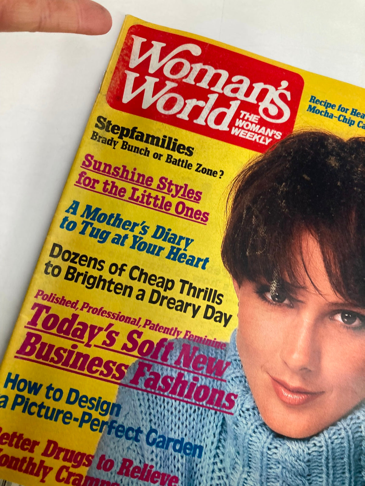 Close-up of the cover of Woman's World Magazine February 18, 1986 showcasing the recipe for Heavenly Mocha-Chip Cake along with other engaging articles for women.