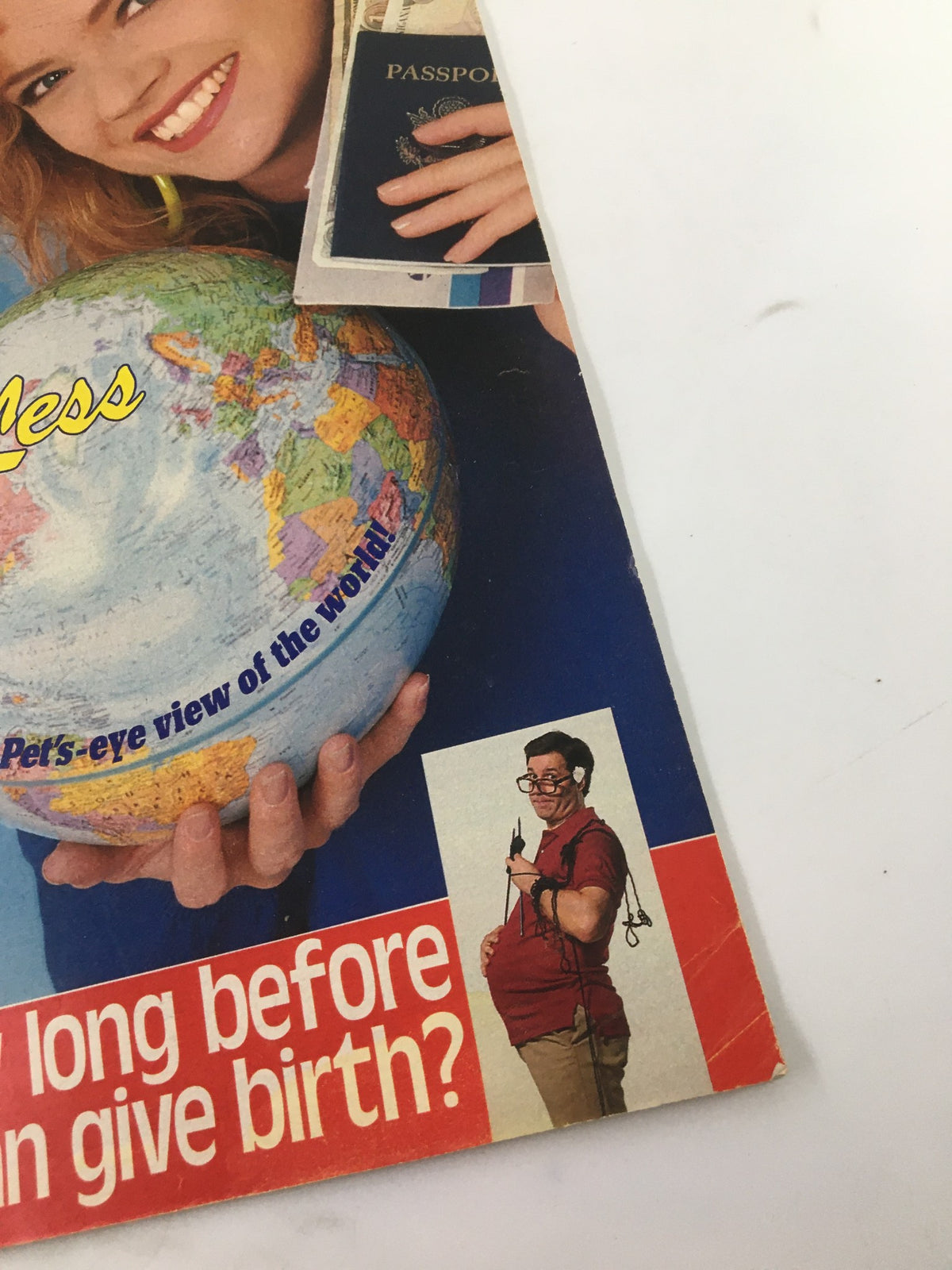 Close-up of Woman's World Magazine March 28, 1989 cover, highlighting a humorous article with a man holding a pregnancy simulation along with a globe, under the headline 'How long before men can give birth?'. The image captures the quirky blend of comedic and informative content present in this issue.