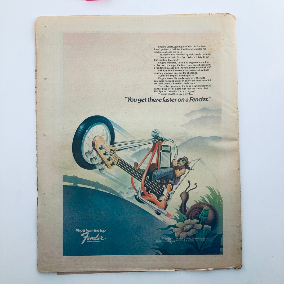 Back cover of the January 17, 1974 Rolling Stone Magazine, featuring a Fender guitar advertisement with a quirky illustration of a musician riding a bike and the phrase 'You get there faster on a Fender'.